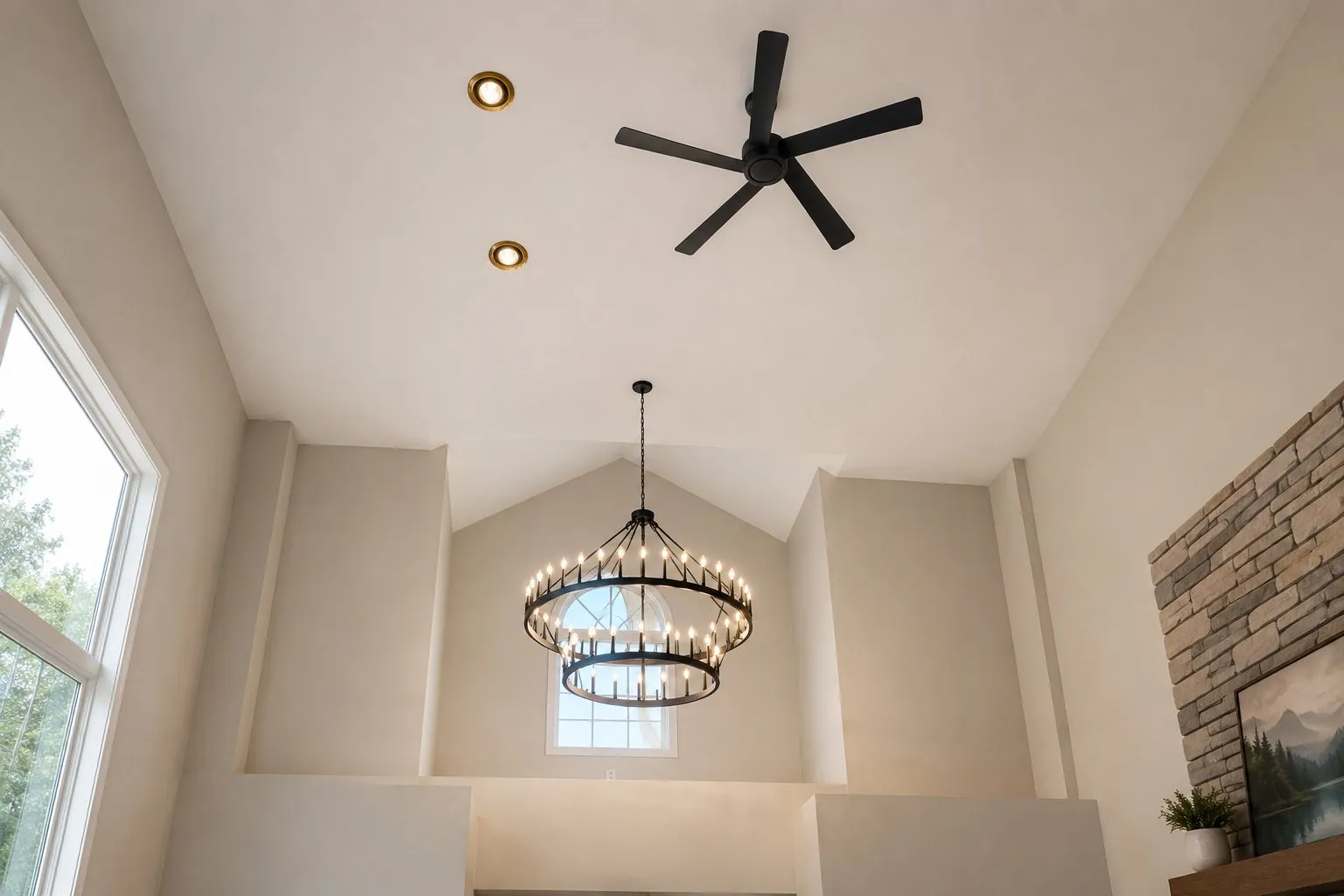 Electrician working safely on tall residential ceiling
